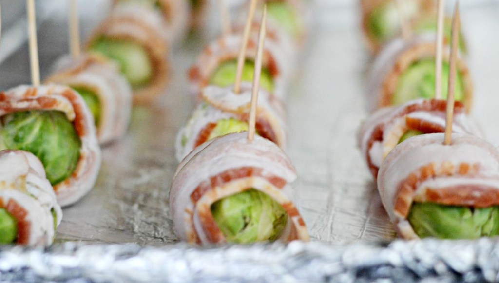 brussel sprouts wrapped in bacon with toothpicks through the center
