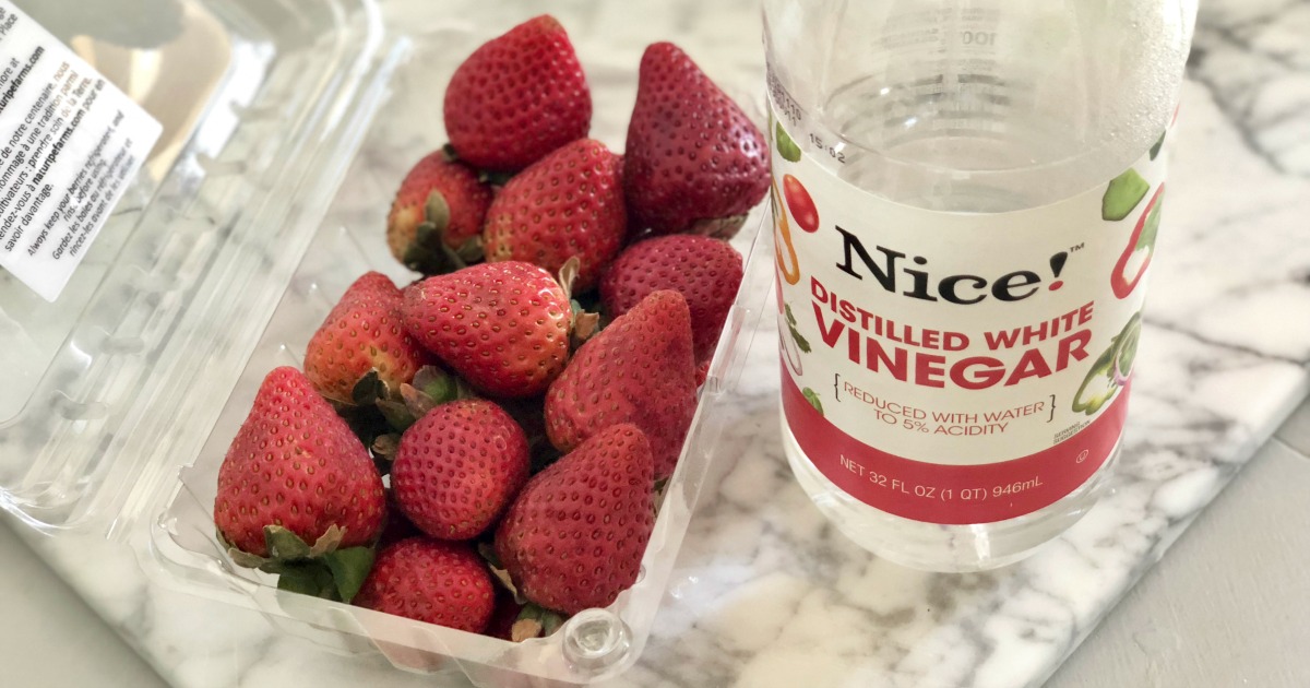 strawberries and a bottle of vinegar to keep them fresh
