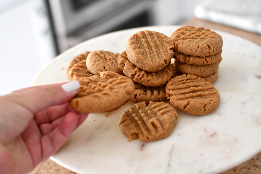 holding keto peanut butter cup cookie 