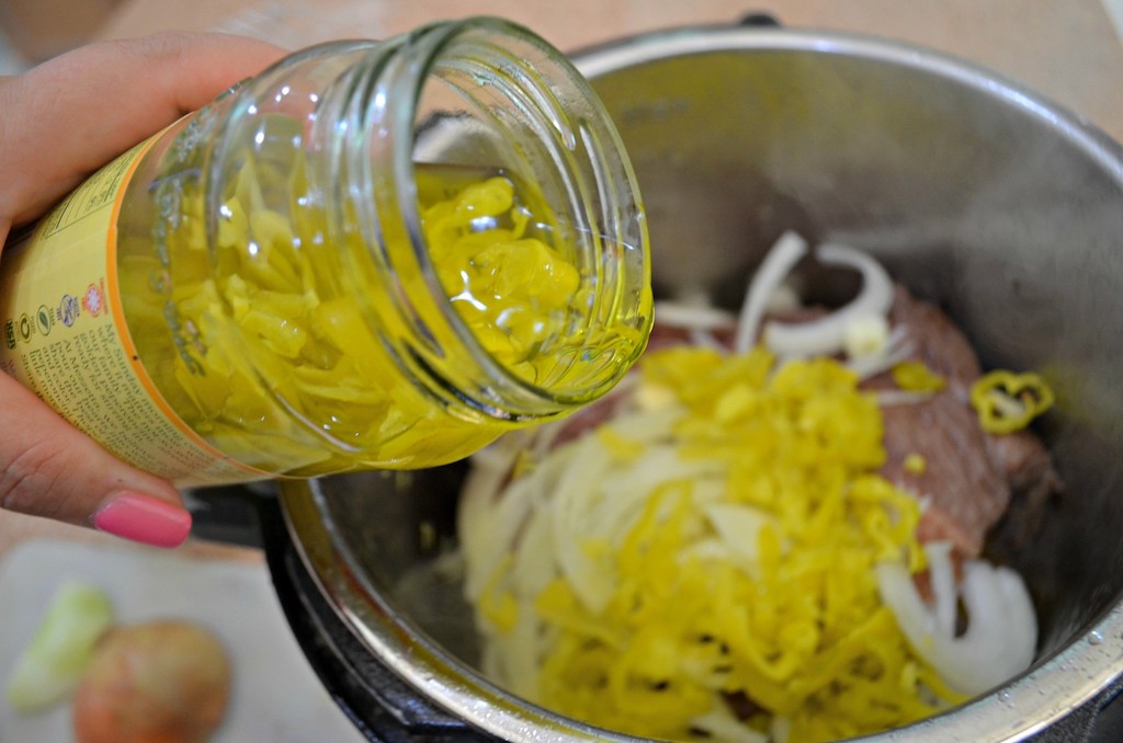 Adding pepperoncini peppers to the Instant pot with beef 