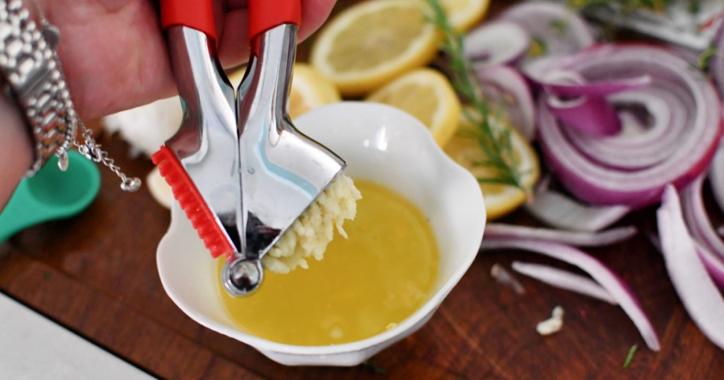 adding garlic cloves to butter