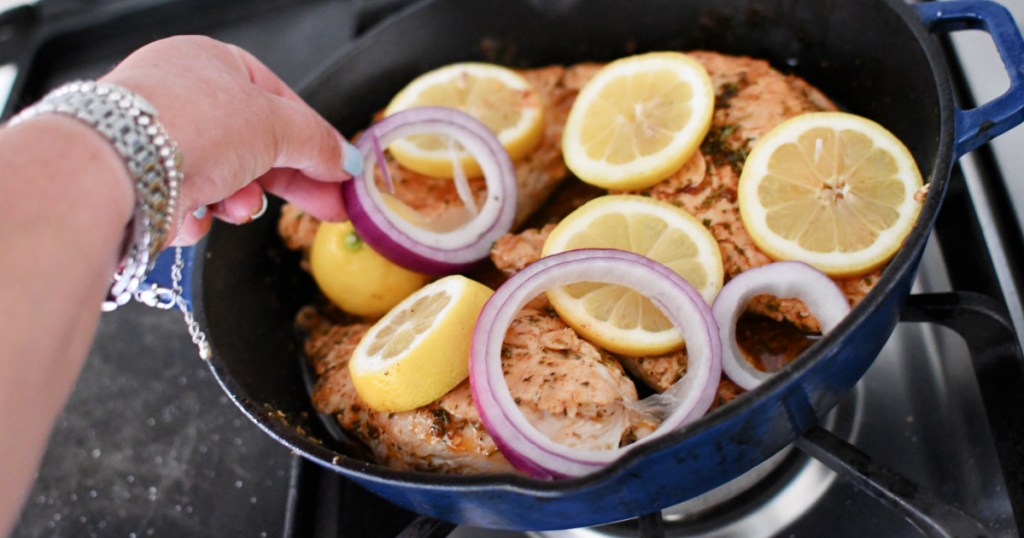 adding lemon and onion to chicken