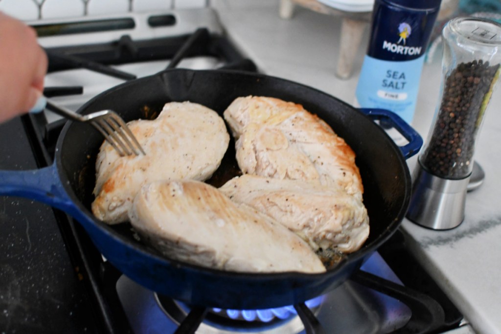 browning chicken breasts on an oven-proof skillet