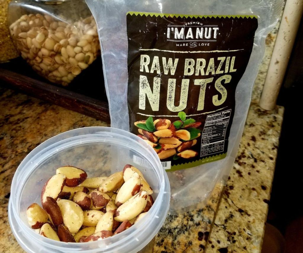bag of Brazil nuts next to snack container