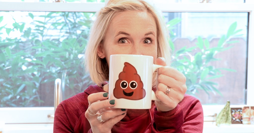 woman holding poop mug in front of face