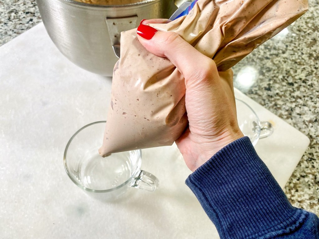 hand piping homemade keto Frosty from bag into glass mug