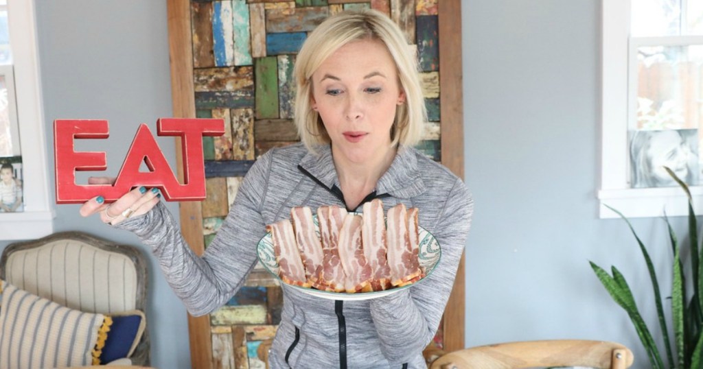 woman holding plate of bacon 