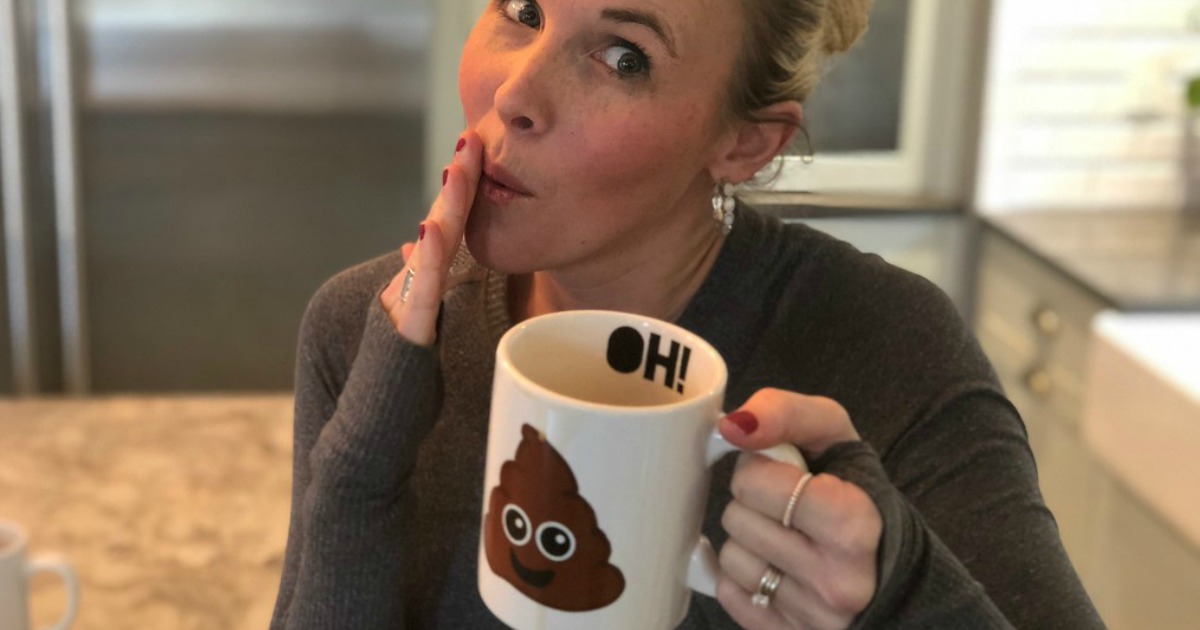 woman holding poop emoji mug