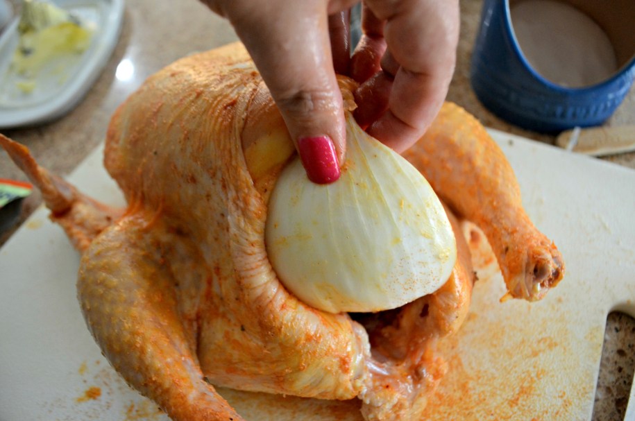 Cook a Whole Chicken in the Air Fryer - inserting an onion