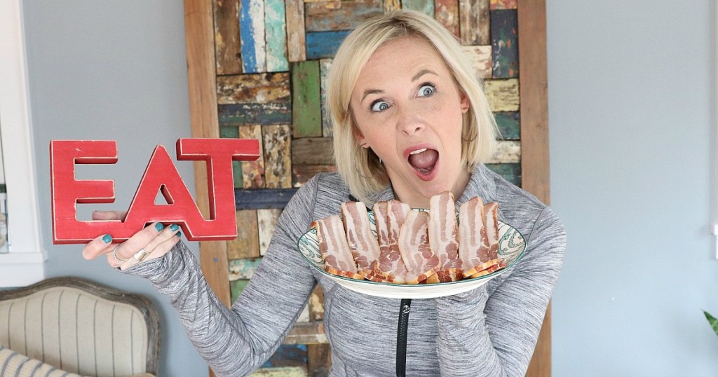 woman holding plate of bacon with mouth open 