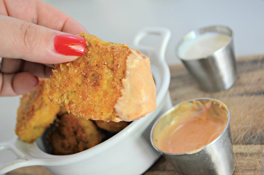 dipping a keto chicken nugget