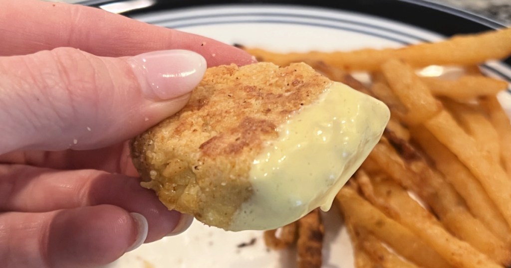 holding a keto chicken nugget