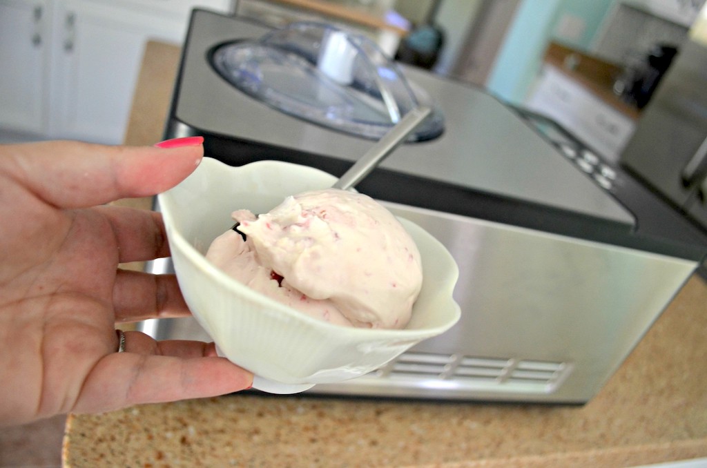ice cream in bowl with ice cream maker in the background