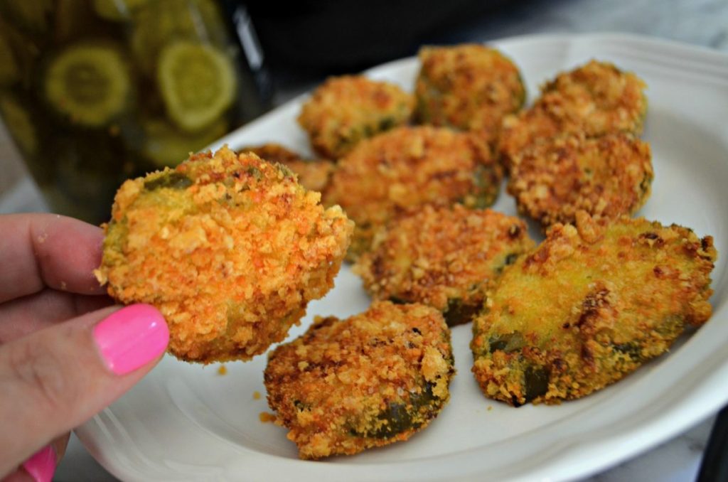 holding fried pickles 