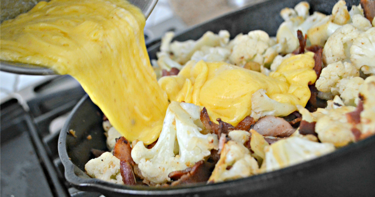 Keto Cauliflower Mac & Cheese – pouring cheese into the pan