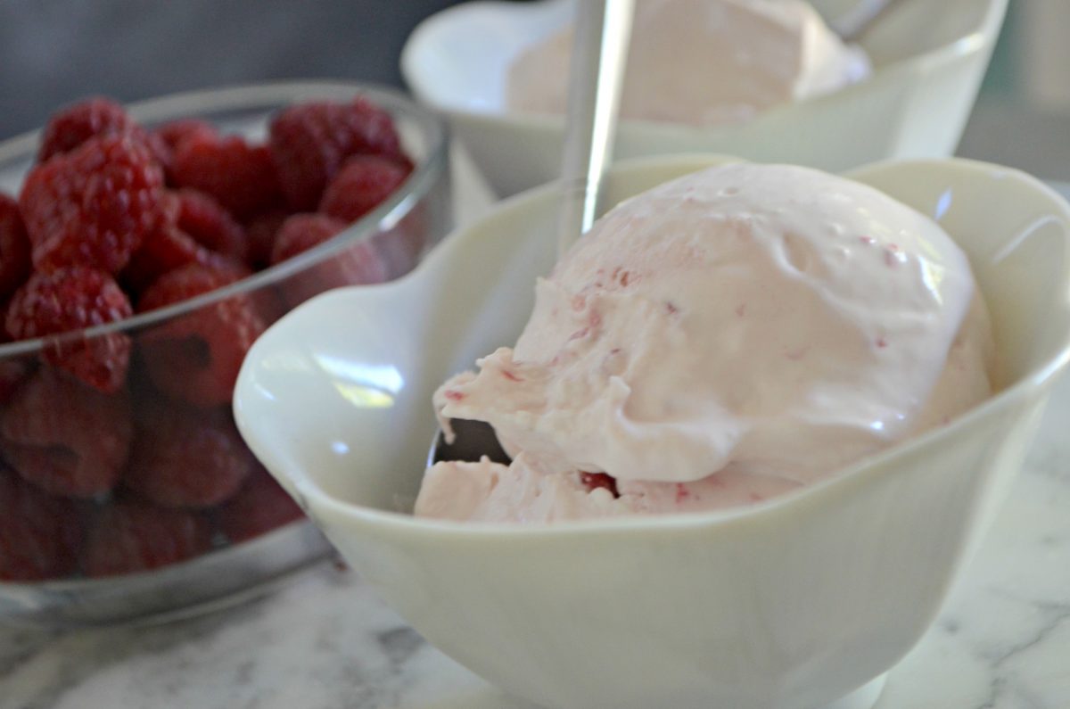 raspberry cheesecake keto ice cream in a bowl close up