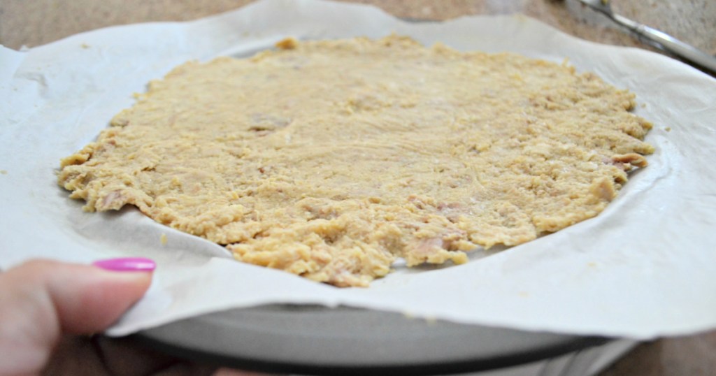 shredded chicken pizza crust on a pan