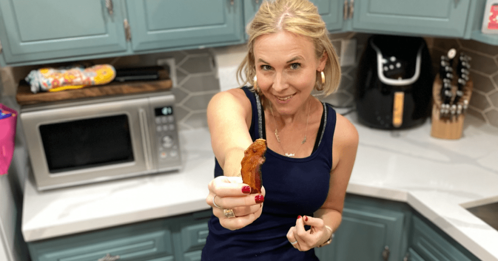 woman holding out bacon 