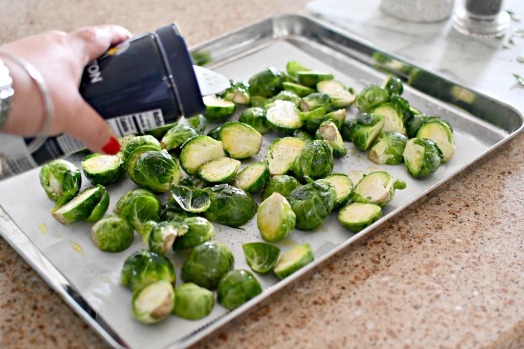 putting salt on brussels sprouts