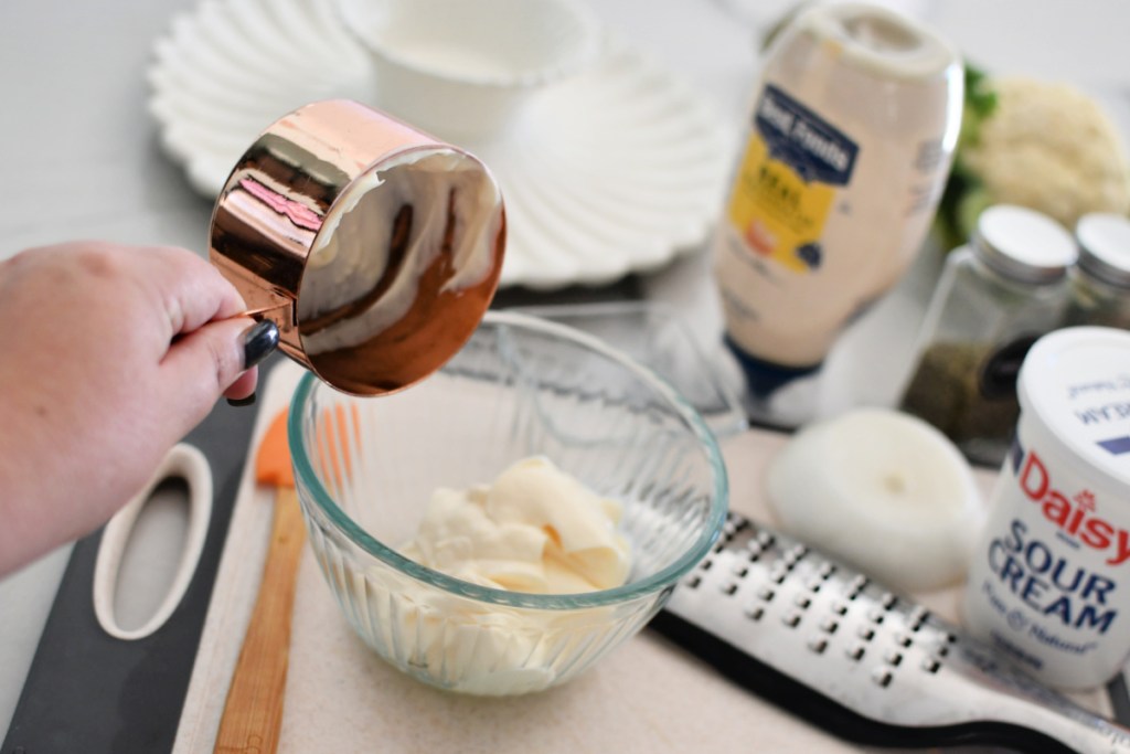 adding mayo to a small bowl