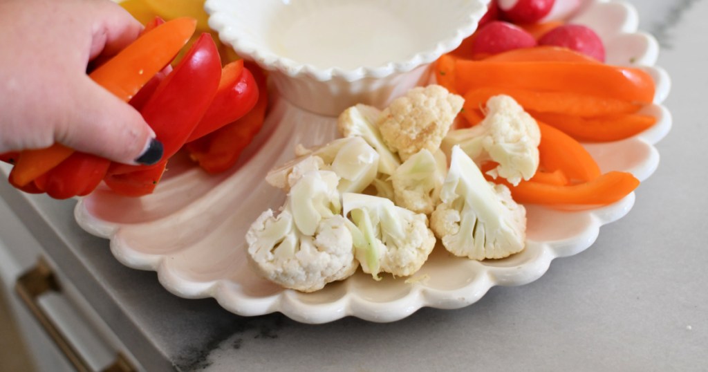 adding veggies to a serving platter