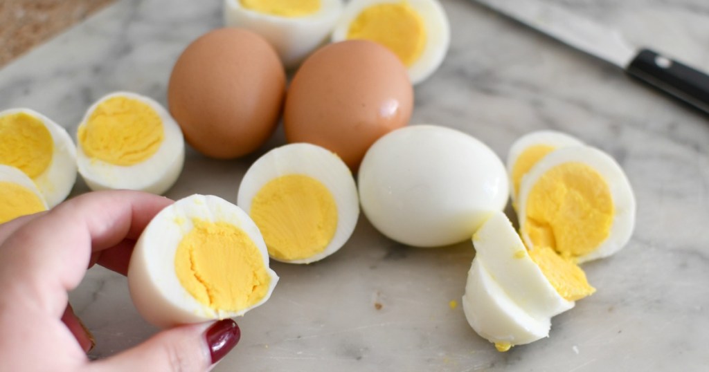 cutting hard-boiled eggs on a cutting board