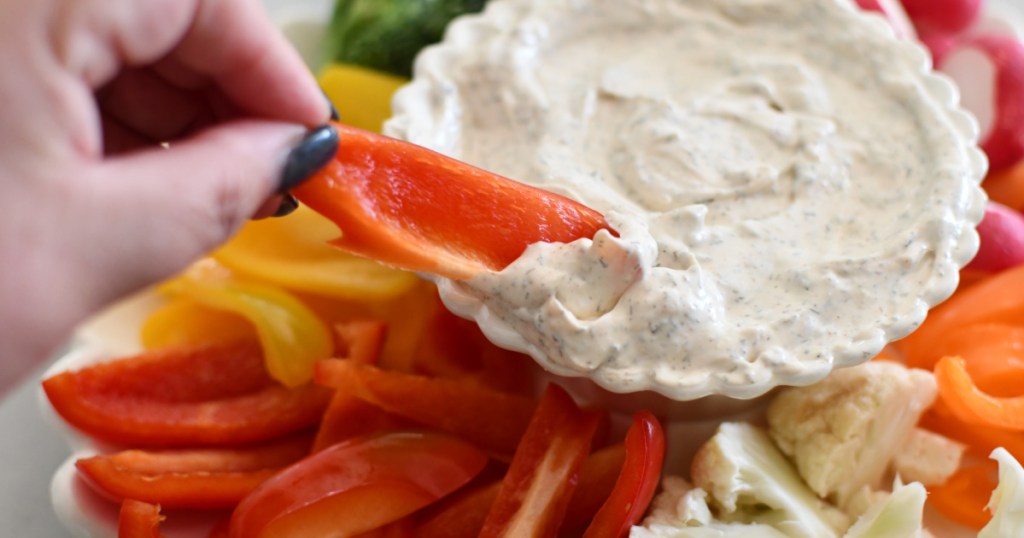 dipping a red bell pepper in keto dill dip