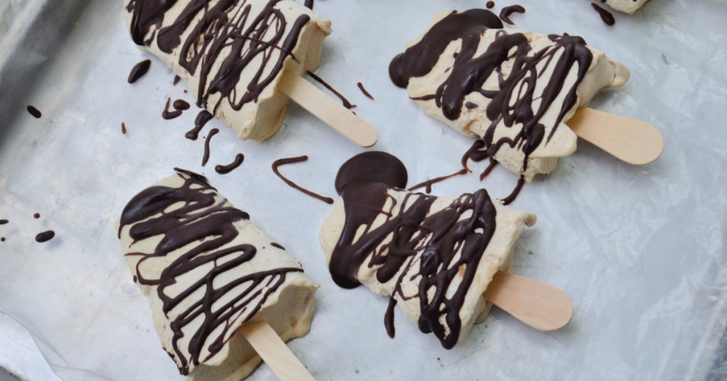drizzling chocolate on almond butter popsicles