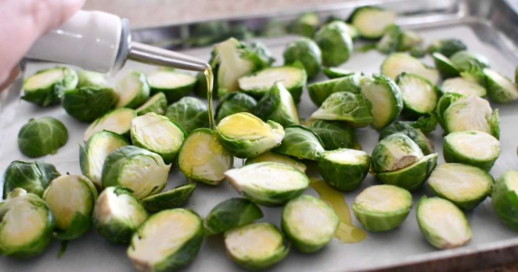 drizzling olive oil on brussels