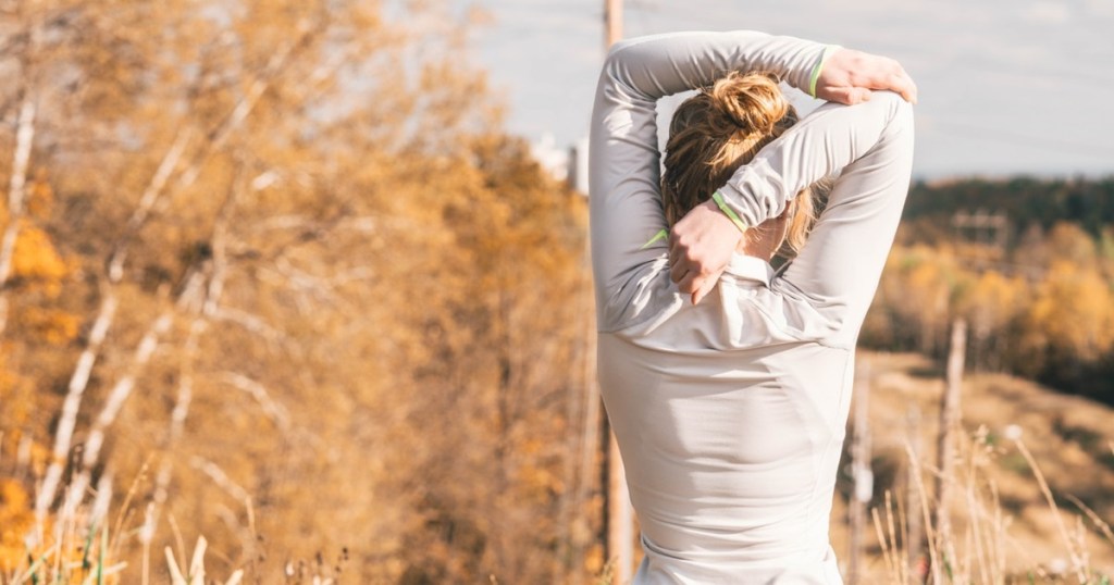 woman stretching for workout on standard keto diet