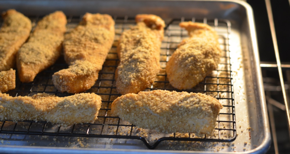 gluten-free baked almond chicken fingers – on a baking sheet