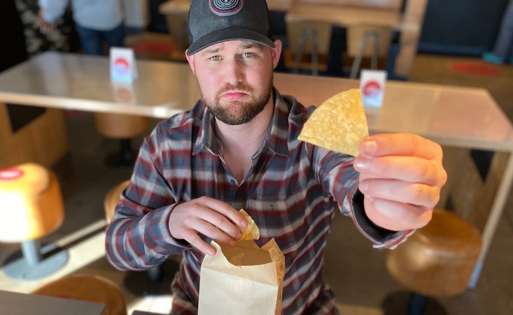man holding tortilla chips