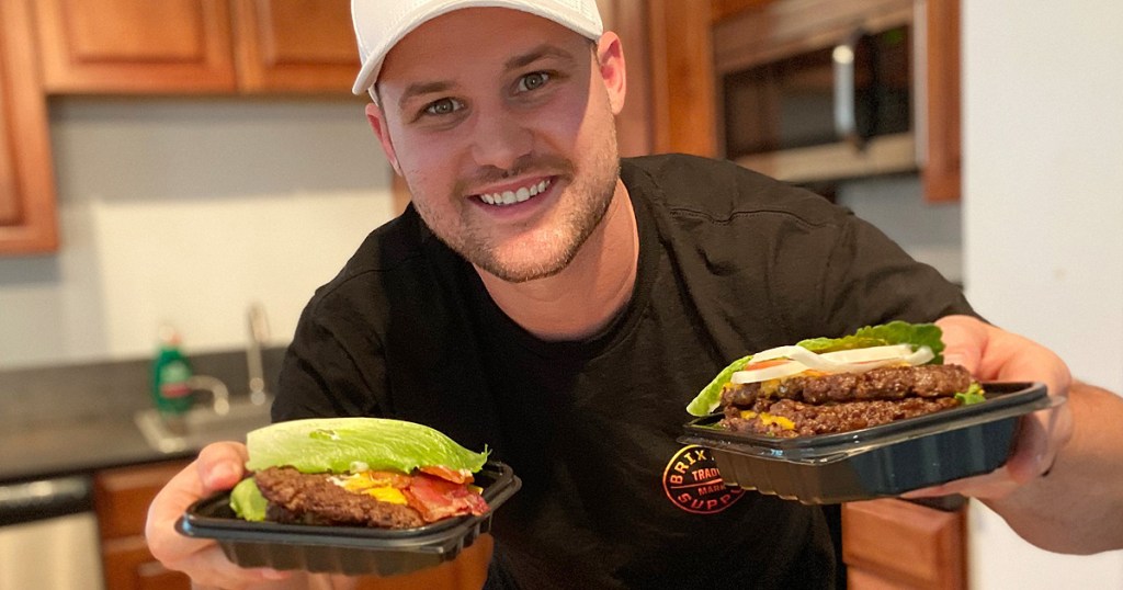 man holding wendys bunless burgers