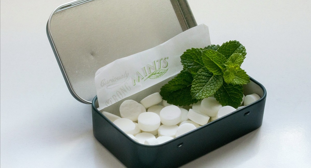 peppermints with mint leaf in tin