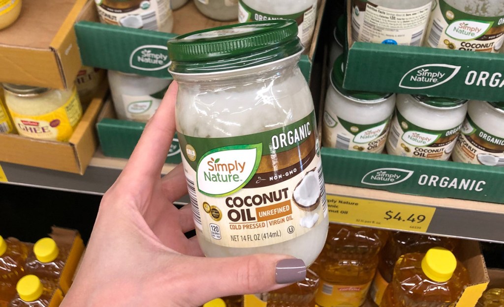 simply nature organic coconut oil held by hand