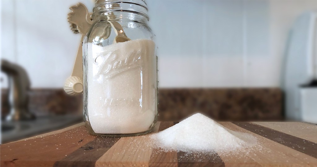 Jar with sugar on counter