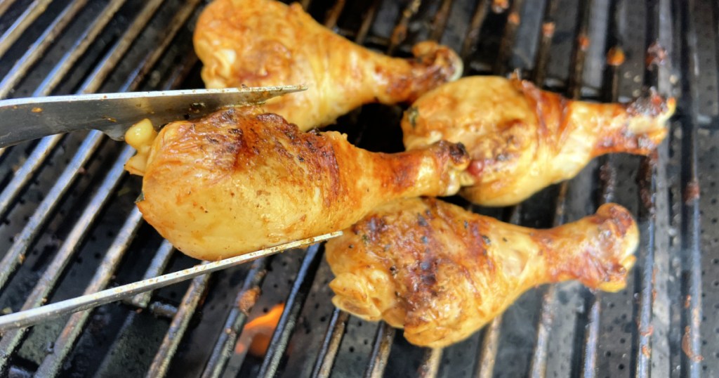 turning keto chicken drumsticks on the bbq grill