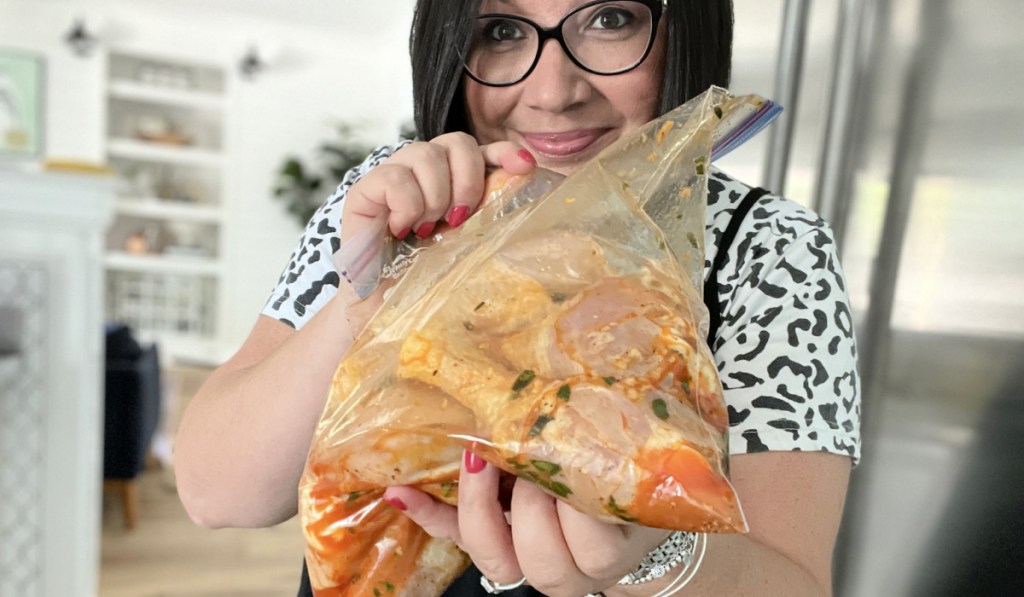 woman holding chicken drumstick