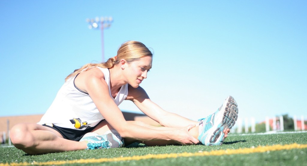 athletic woman stretching muscles