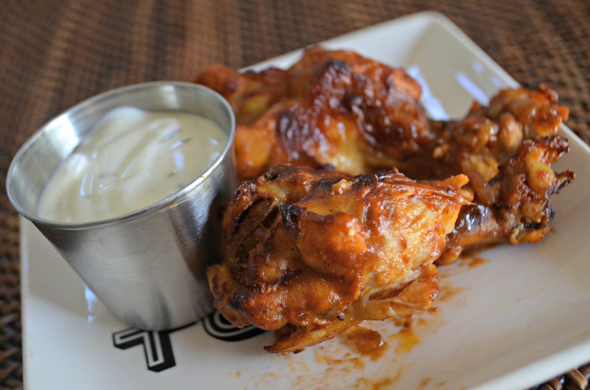 Slow Cooker Buffalo BBQ keto Wings - on a plate with dipping sauce