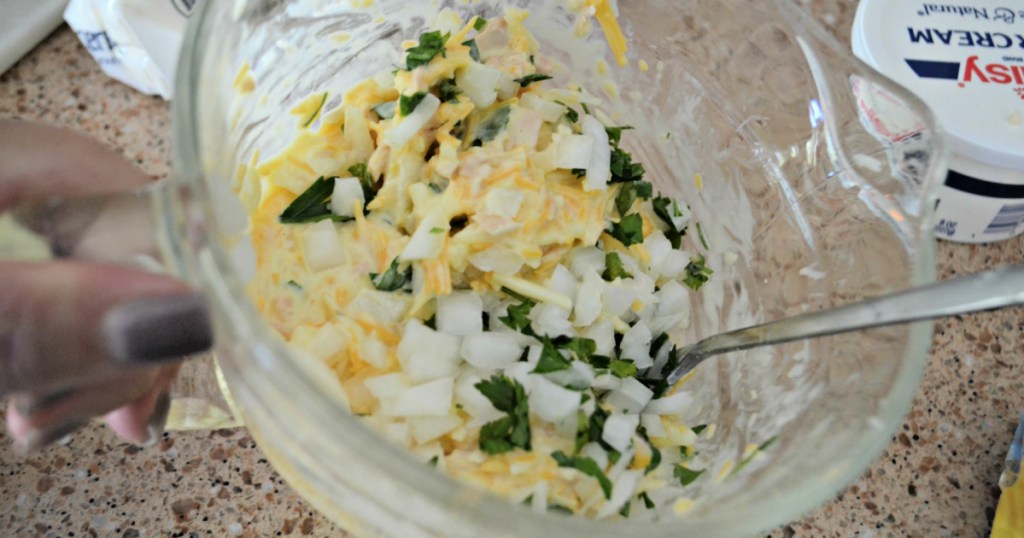 adding onions to tuna cups