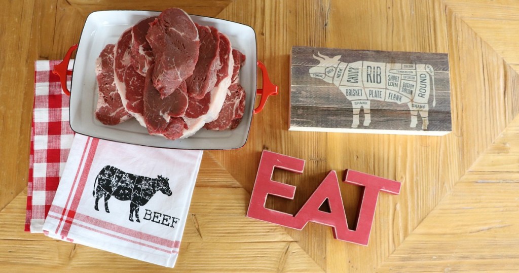 ribeye steaks with meat signage and towel