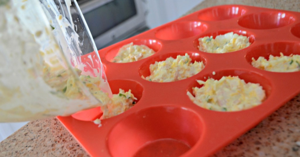 pouring tuna egg cups into muffin tin