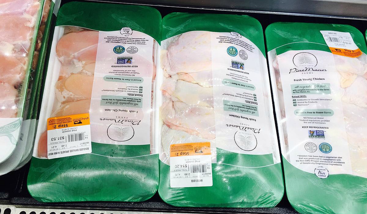 keto whole foods shopping tips to save money — bulk packages of chicken thighs in cooler