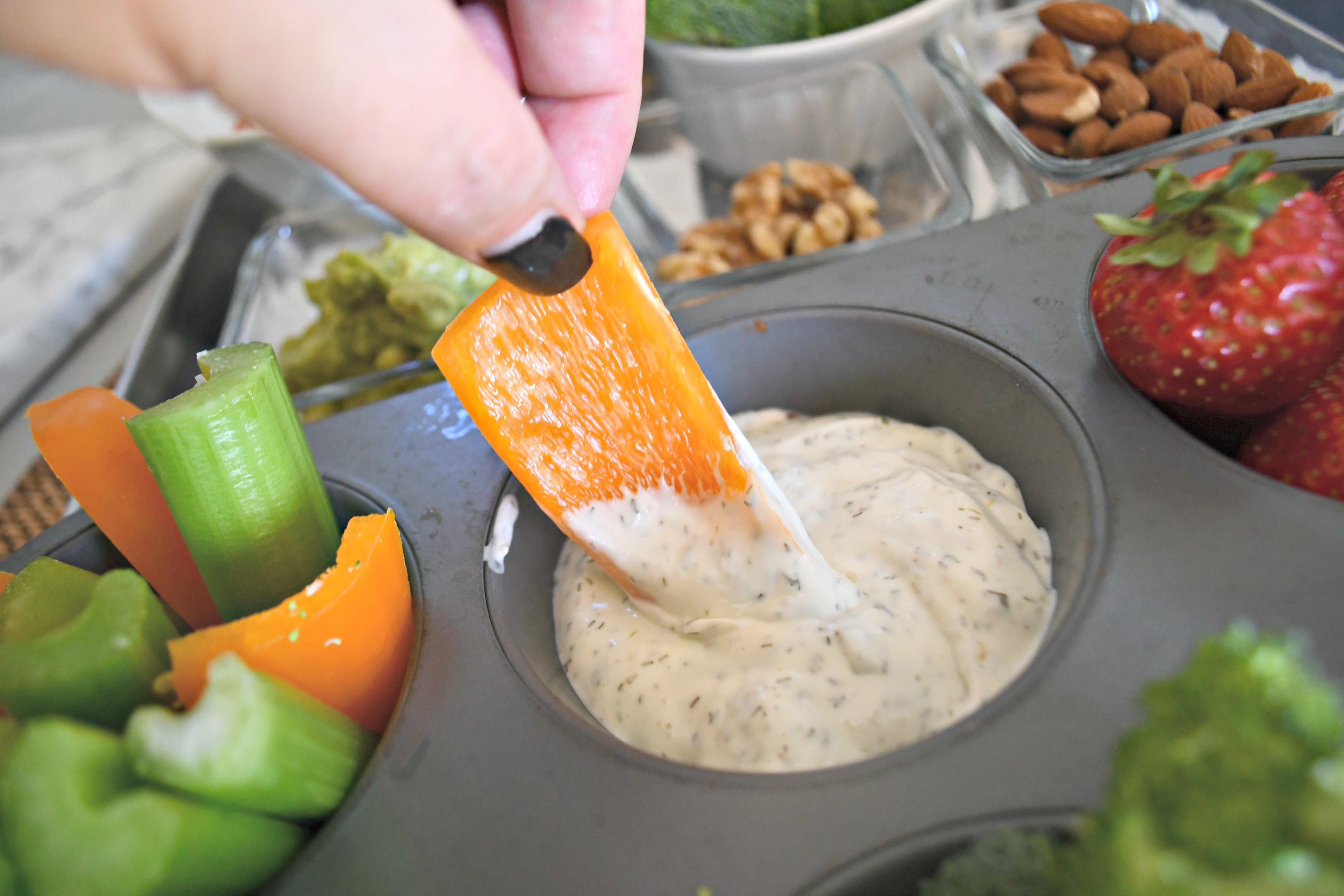 Easy Snack Based Keto Dinner - dipping orange bell pepper into dip