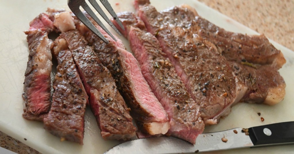 sliced steak on cutting board