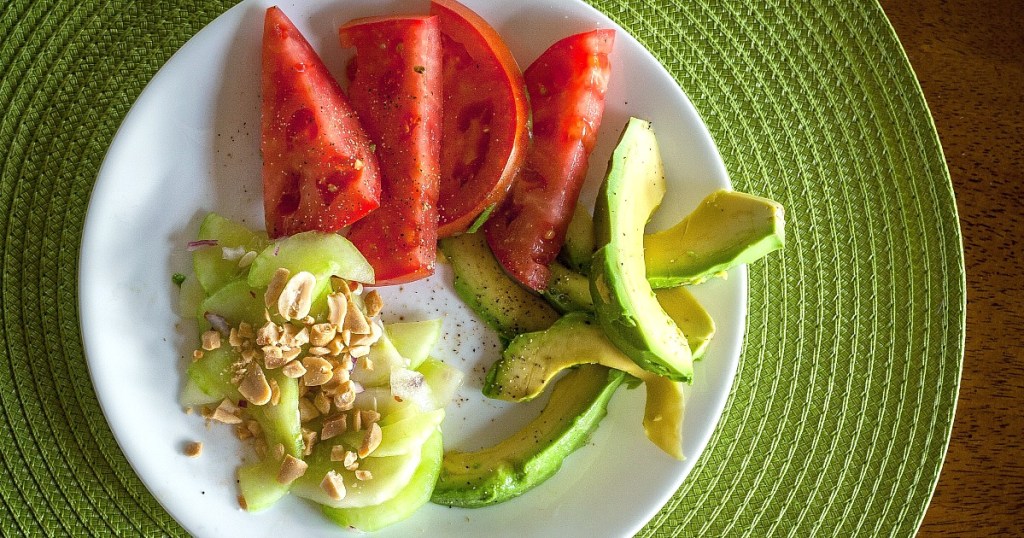 vegan keto diet — avocado, cucumber, and tomato on plate