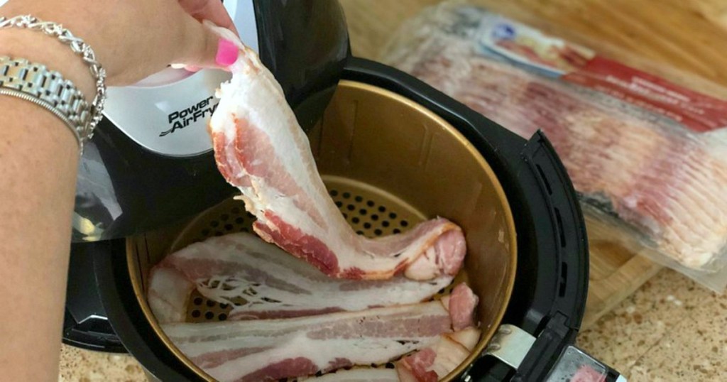 keto and cholesterol — bacon being placed in air fryer for cooking