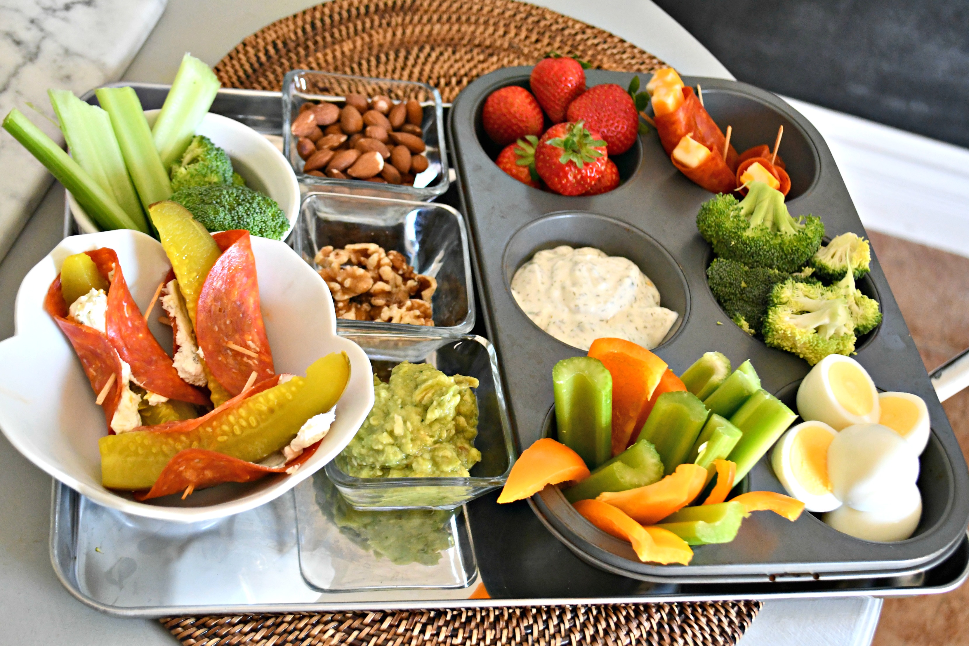a tray filled with keto finger foods like fruits, veggies, meat, and cheese