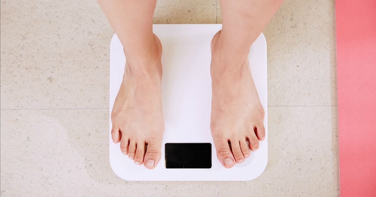 woman standing on scale waiting for weight